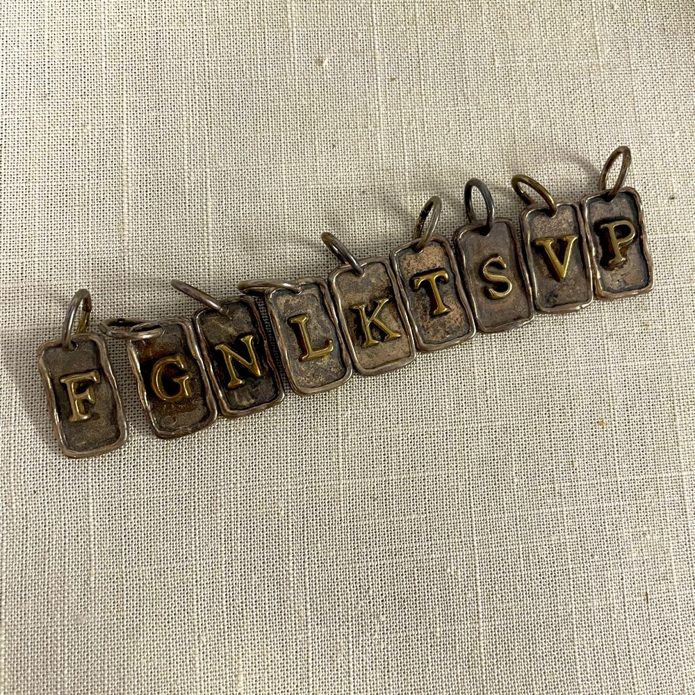 Waxing poetic. Tag Insignia charm